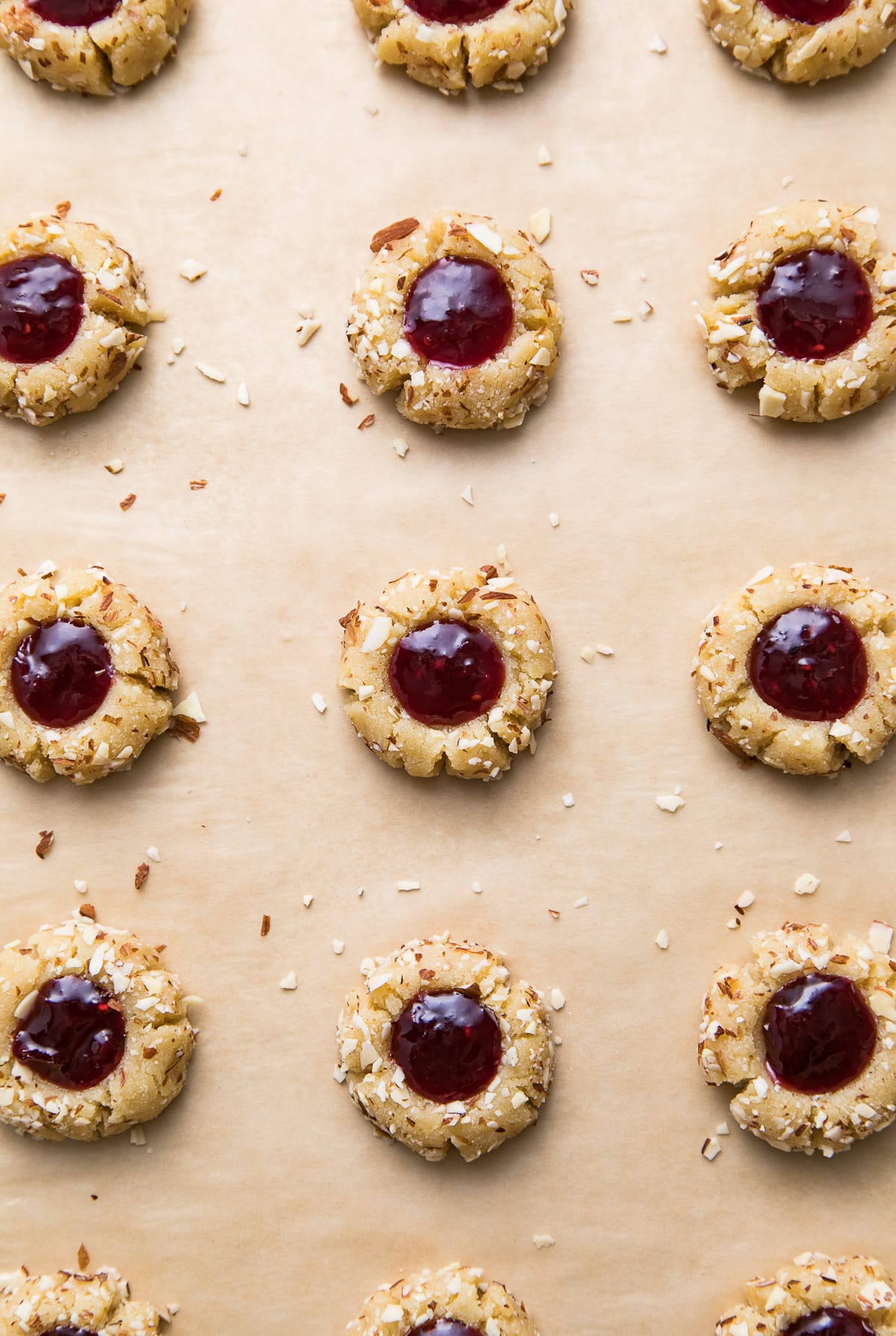 top down view of healthy almond thumbprint cookies on a baking sheet and ready for the oven.