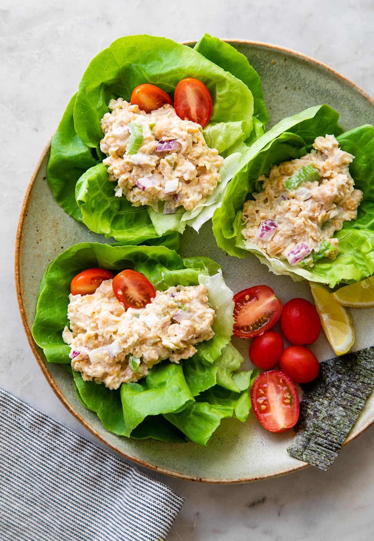 top down view of healthy vegan chickpea tuna salad wraps on a plate.