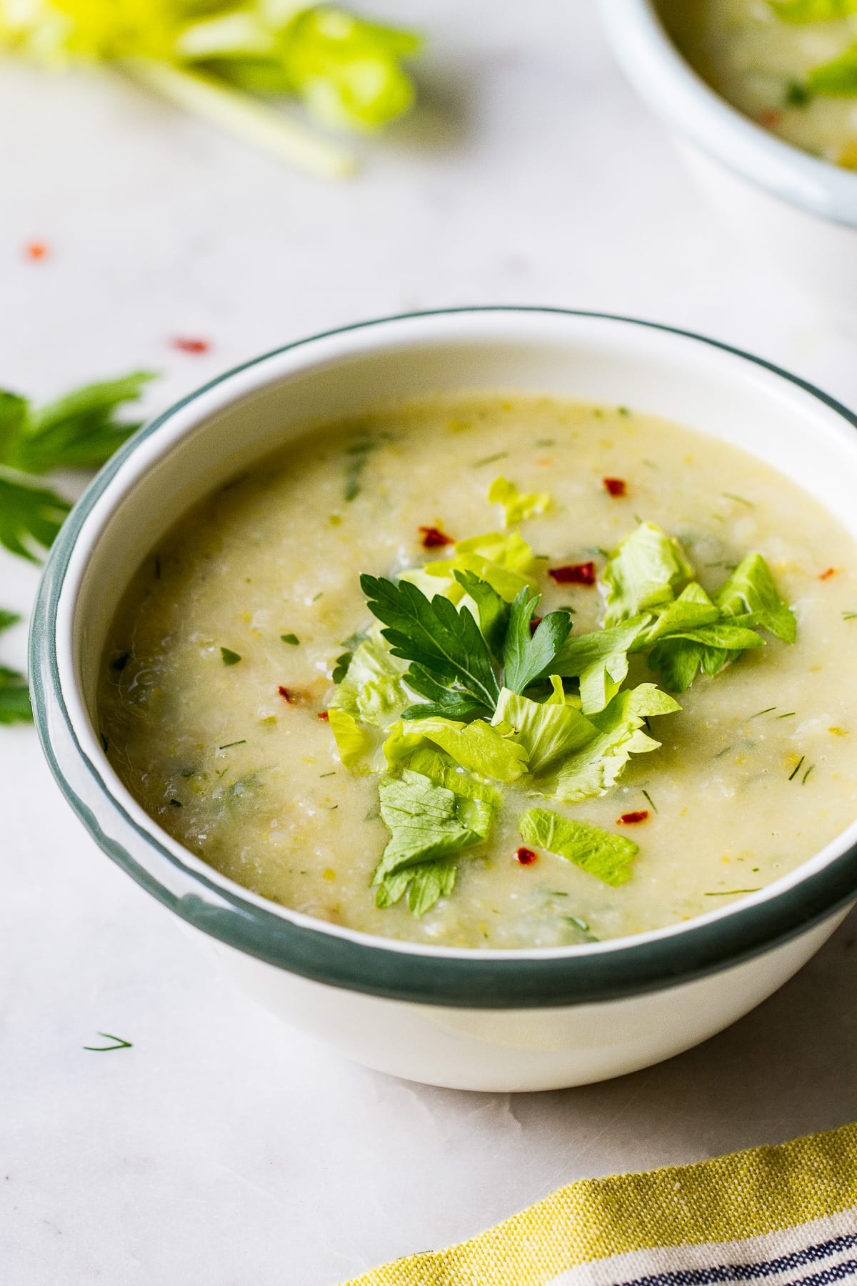 side angle view of a bowl with a serving of healthy celery soup.