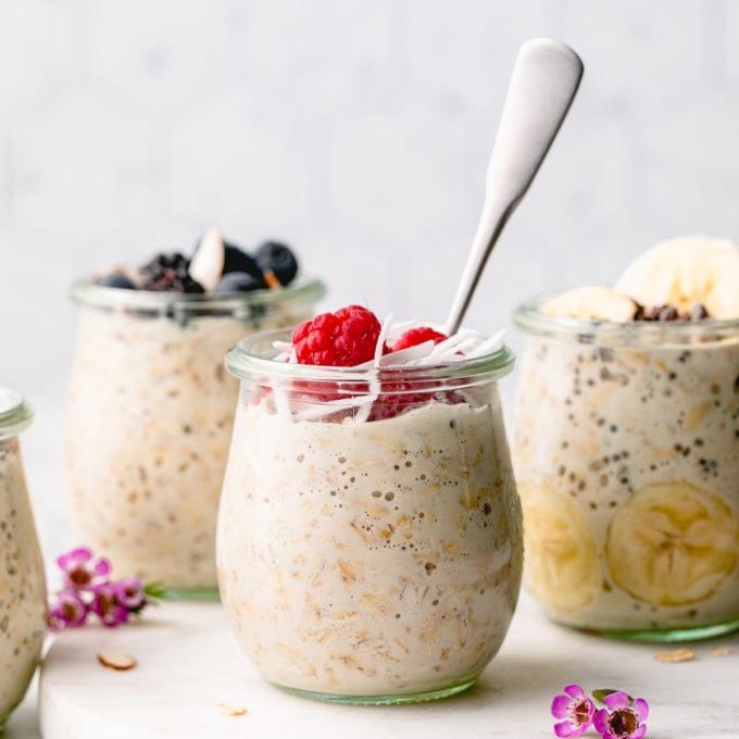 head on view of a group of mason jars with overnight oats with toppings.