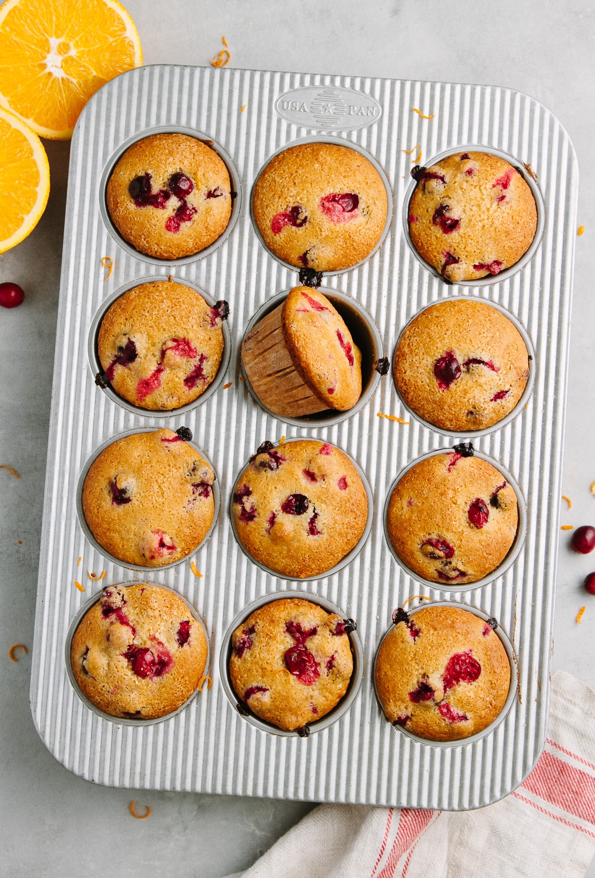 top down view of freshly made healthy vegan cranberry orange muffins in a muffin tin.