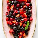 summer cherry berry fruit salad on a pink platter