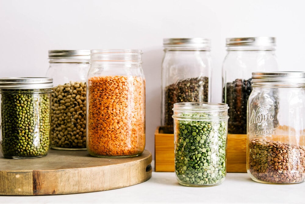 an assortment of legumes in mason jars.